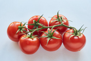 Fresh cherry tomatoes on white background