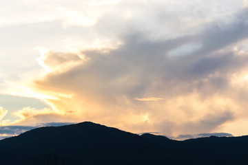 silhouette shot image of mountain and sunset sky in background.