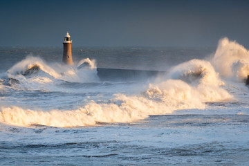 Stormy Waves at Tynemouth Lighthouse, as the sea hits Tynemouth North Pier, resulting in high crashing waves cascading into the mouth of the River Tyne