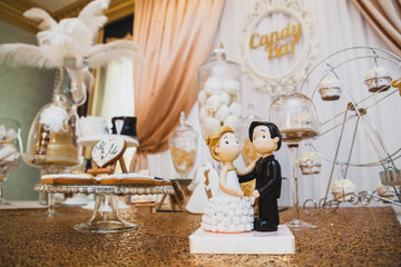 Bride and groom on a wedding cake. Edible figure.