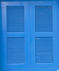 The blue wooden window frames in white