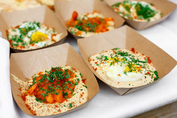 Street vendor's hummus, closeup of snacks in craft package