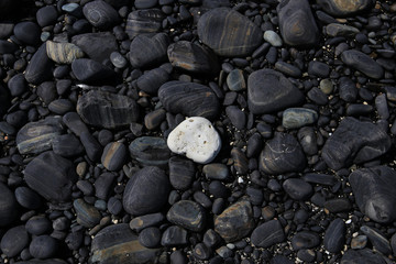 white heart stone Soft feather against  background stone 