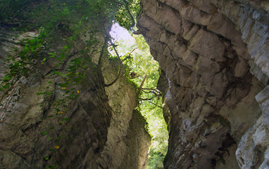 hidden white rocky gorge in the view of the valley below with a narrow rock corridor meshed walls
