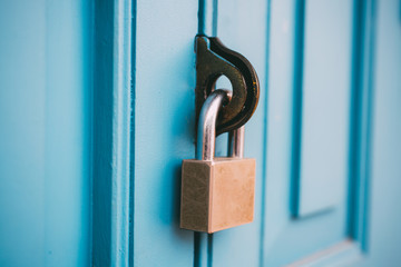 Closed vintage lock on wooden door.