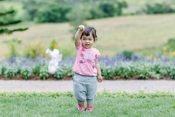 The little girl Running for fun in the garden.