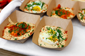 Street vendor's hummus, closeup of snacks in craft package