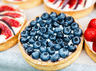 Closeup of blueberry tart dessert tray assorted