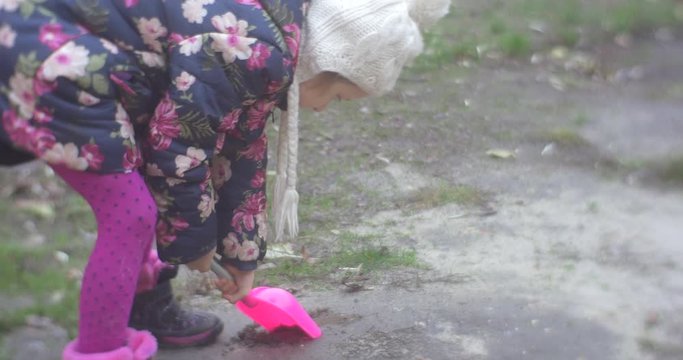 Girl Digs Ground With Pink Shovel