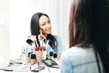 Beautiful young woman making make-up