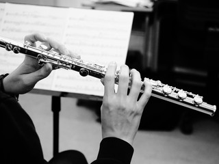 Hands playing a flute