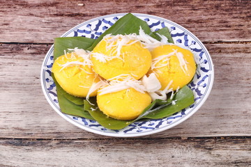 Toddy palm cake topped roll coconut .