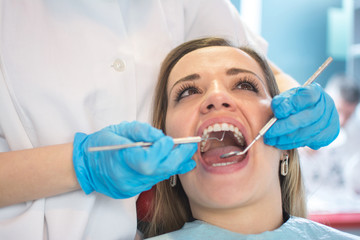 Dentist examining a patient's teeth in the dental office.