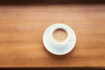 Cup of coffee on a wooden table.