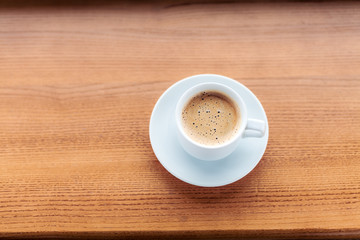 Cup of coffee on a wooden table.