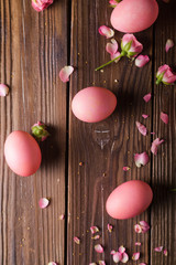 Pink Easter eggs on wodden background. Copyspace. Still life photo of lots of pink easter eggs.Background with easter eggs. Pink eggs and roses. Easter photo concept