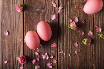 Pink Easter eggs on wodden background. Copyspace. Still life photo of lots of pink easter eggs.Background with easter eggs. Pink eggs and roses. Easter photo concept