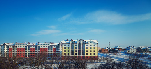 multistoried building near a park in winter