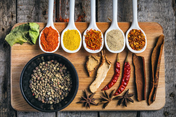 Various colorful spices on wooden table