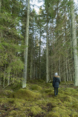 Fototapeta premium Woman on her way into a big forest