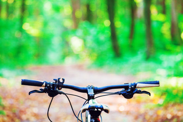 Mountain biking down hill descending fast on bicycle. View from