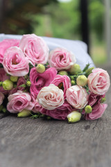 Beautiful bouquet of pink roses on wooden background