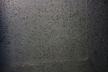 Water drops on gray background closeup