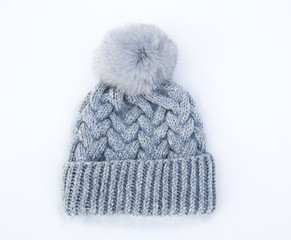 Gray knitted woolen hat with fur pompom