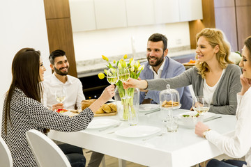 Friends sitting at a dining table celebrating