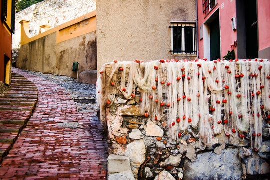small lane in touristic area known as boccadasse in genoa where some fishing nets are drying