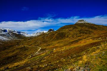 Great landscape with fall colors and new snow on the mountain tops, in western Norway