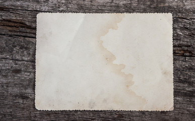 Aged photo frame on wood background