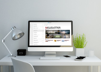 modern clean workspace with newsletter on screen