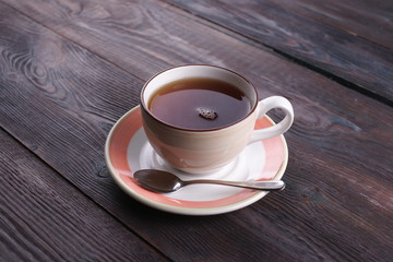 Obraz premium cup of black tea on a wooden table