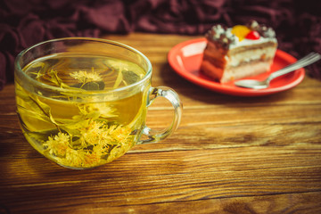 cup of tea and cake on a wooden table