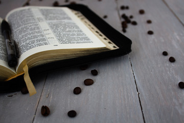 bible and coffee on wooden board