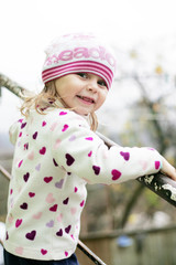 Baby in a pink cap smiles