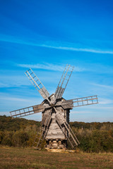 Fototapeta na wymiar Old wooden windmill on the hill.