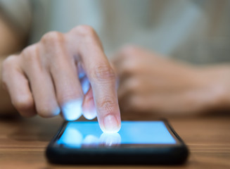 Close up of people hand using smartphone in technology and socia