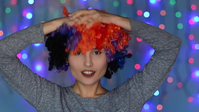 Woman with colored afro wig posing, having fun, animation in the background