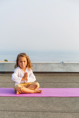 Baby doing yoga on the roof