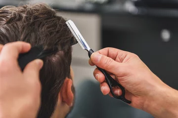 Photo sur Plexiglas Salon de coiffure Professional barber doing hairstyle for man