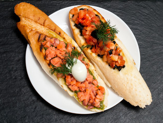 Sandwich with salmon and tomatoes for breakfast. . View from above