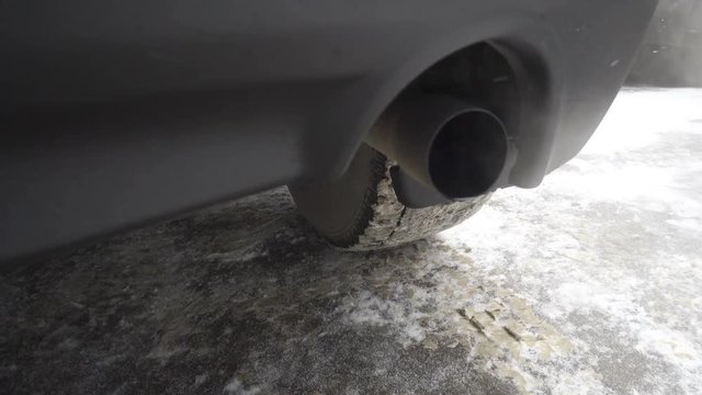 Toxic gases are exhausted on the tailpipe of a car, polluting the atmosphere.