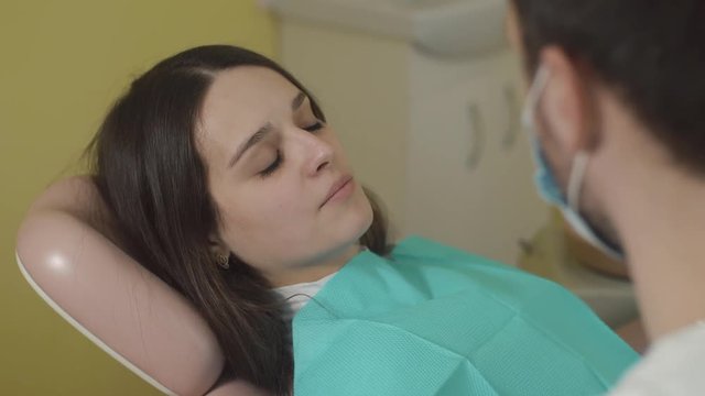 Examination Of The Mouth And Teeth. Beautiful young woman sitting in the dental chair.