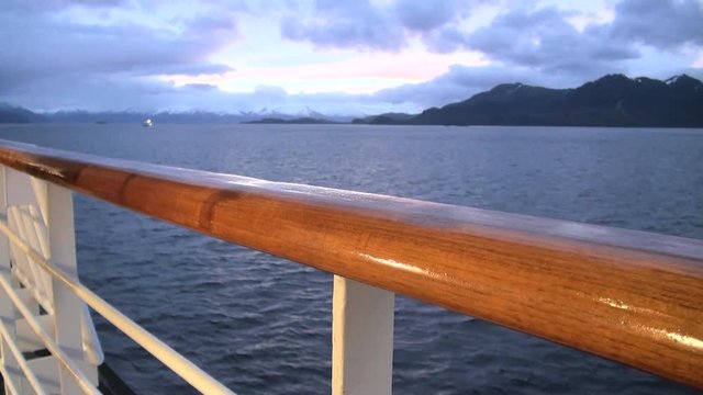 Sunset in Chilean Fjord - Deck railing of cruise ship in the Pacific Ocean - Travel Destination - South America - Cruising Antarctica