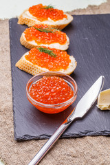 Baguette with red caviar, knife