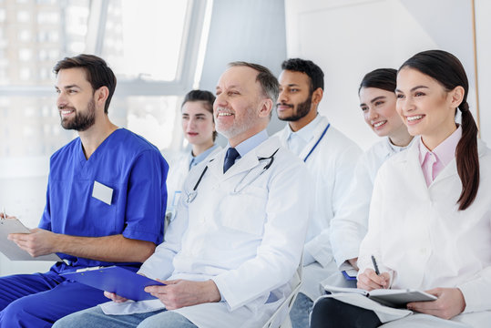 Cheerful medical team listening to new information