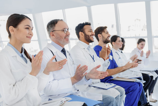 Joyful medical team clapping hands