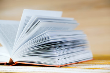 Open book on wooden table. Back to school. Copy space